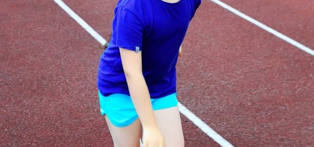 Girl with down syndrome running track